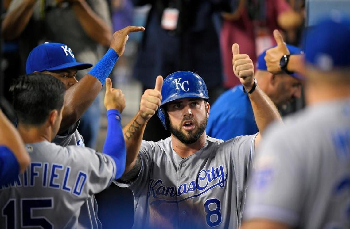 Kansas City Royals' Mike Moustakas is congratulated by teammates after scoring during the fourth inning of the team's baseball game against the Los Angeles Dodgers, Friday, July 7, 2017, in Los Angeles.