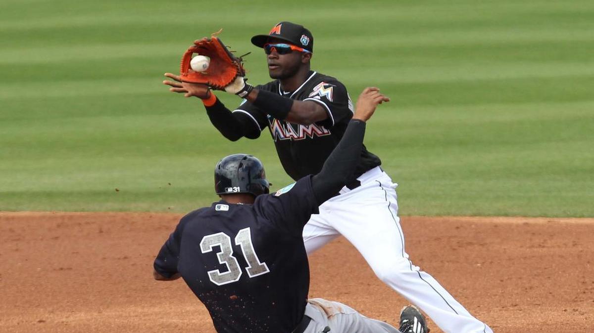 Adeiny Hechavarria, of the Miami Marlins, puts out Aaron Hicks, of the New York Yankees, in the third inning during a spring training game between the Miami Marlins and the New York Yankees at Roger Dean Stadium in Jupiter on Tuesday, March 8, 2016.