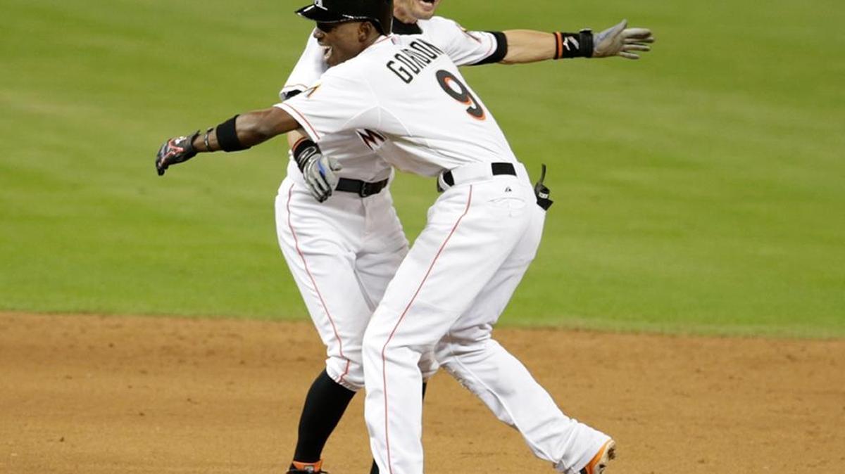 
Miami Marlins' Ichiro Suzuki, left, celebrates with Dee Gordon after Gordon drove in the winning run with a double in the 11th inning against the Philadelphia Phillies, Wednesday, Sept. 23, 2015, in Miami. 
