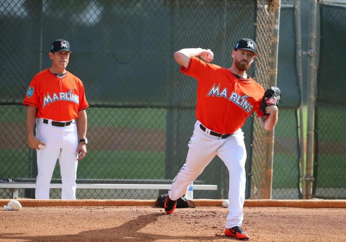 Miami Marlins pitching coach Juan Nieves looks as pitcher Dan Straily pitches during the spring training baseball workouts for pitchers and catchers at Roger Dean Stadium on Wed., February 14, 2018 in Jupiter, FL.