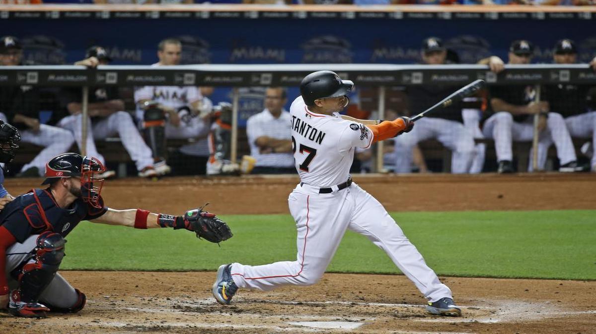Miami Marlins rightfielder Giancarlo Stanton hits a home run during the fourth inning of a baseball game against the Atlanta Braves at Marlins Park in Miami on Sept. 28, 2017.