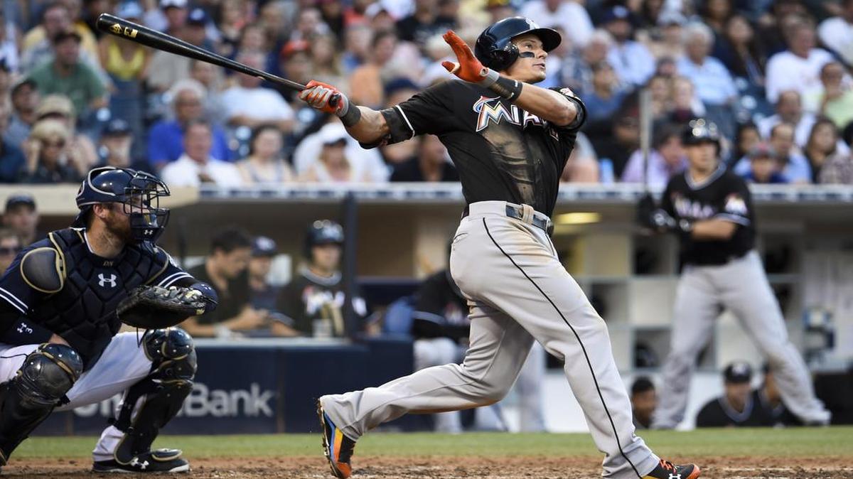 
Miami Marlins’ Derek Dietrich (32) hits a solo home run during the seventh inning of a baseball game against the San Diego Padres at Petco Park July 25, 2015 in San Diego. 
