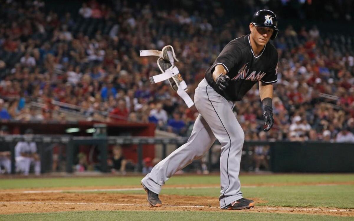 Miami Marlins' Jeff Mathis heads down to first base after earning a walk during the seventh inning of a baseball game against the Arizona Diamondbacks Friday, June 10, 2016, in Phoenix. The Marlins defeated the Diamondbacks 8-6.