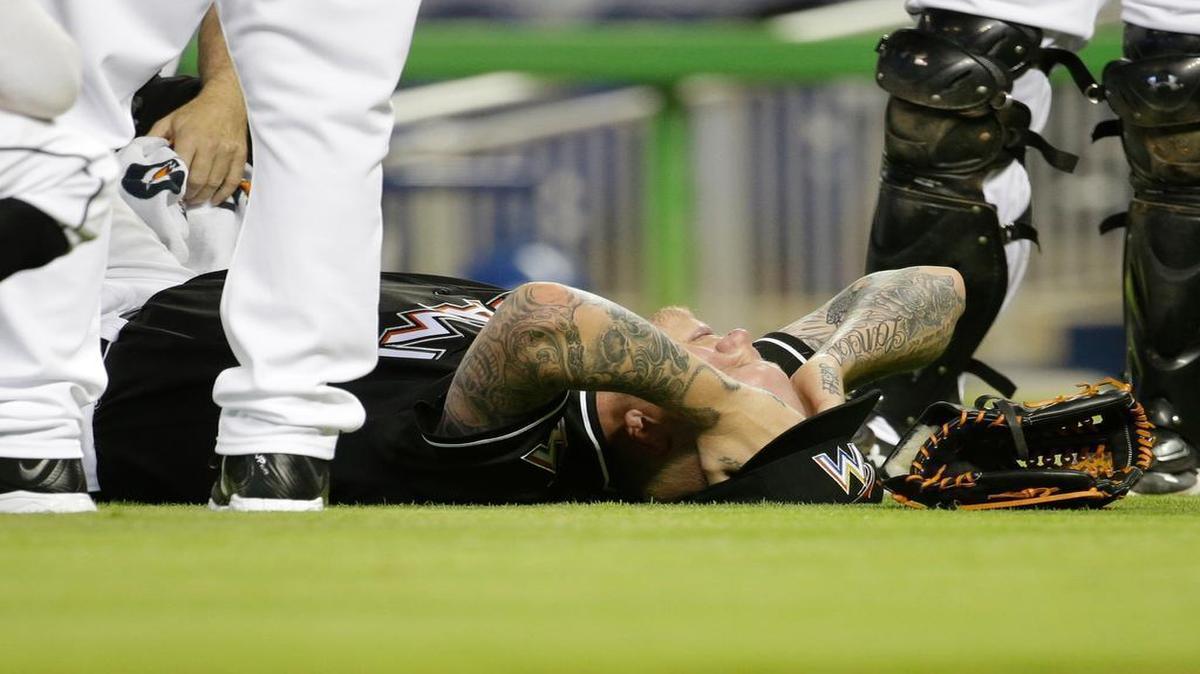 
Miami Marlins starting pitcher Mat Latos lies on the field after being hit with a ball in the fourth inning of a baseball game against the Atlanta Braves at Marlins Park in Miami on May 16, 2015.

