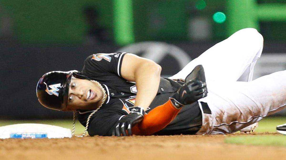 Miami Marlins' Giancarlo Stanton rolls over at second base after he was put out during the ninth inning of a baseball game, Saturday, Aug. 13, 2016, in Miami. Stanton singled with two out in the ninth but was an easy out trying to stretch the hit into a double. The White Sox defeated the Marlins 8-7.