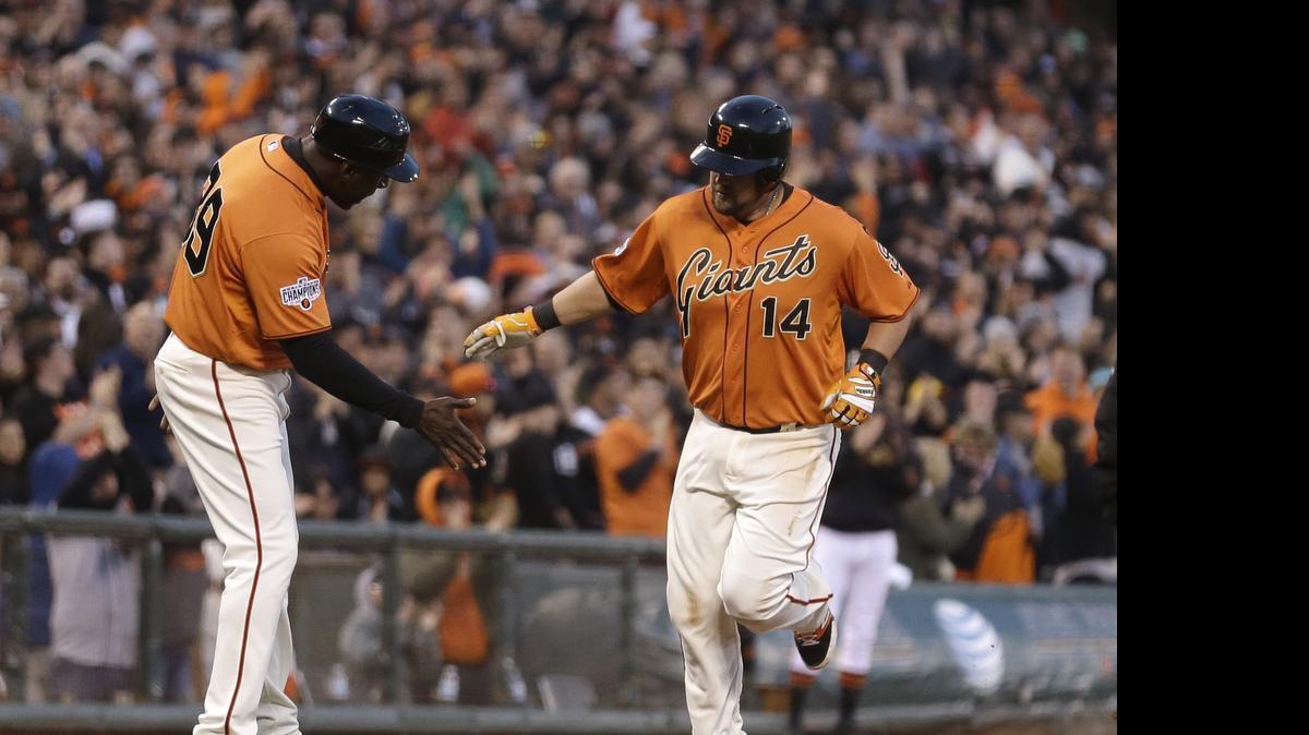 
San Francisco Giants' Casey McGehee, right, is congratulated by third-base coach Roberto Kelly after McGehee hit a grand slam off Miami Marlins' Jarred Cosart in the second inning Friday, May 8, 2015, in San Francisco.
