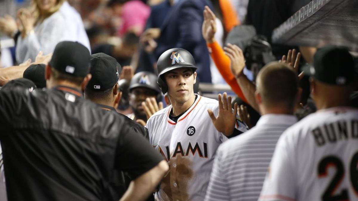 Then-Miami Marlins center fielder Christian Yelich is congratulated by teammates during a game against the Atlanta Braves on April 11, 2017. The former Marlin, who was traded to the Milwaukee Brewers, talked on 790 The Ticket about the trade and his thoughts on Derek Jeter.