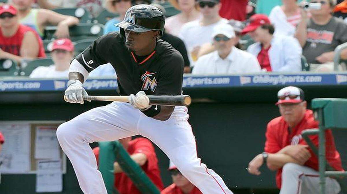 
Miami Marlins’ Dee Gordon bunts for a single in the first inning of the Miami Marlins vs Washington Nationals spring training game at Roger Dean Stadium in Jupiter Fl. on Tuesday, March 10, 2015.
