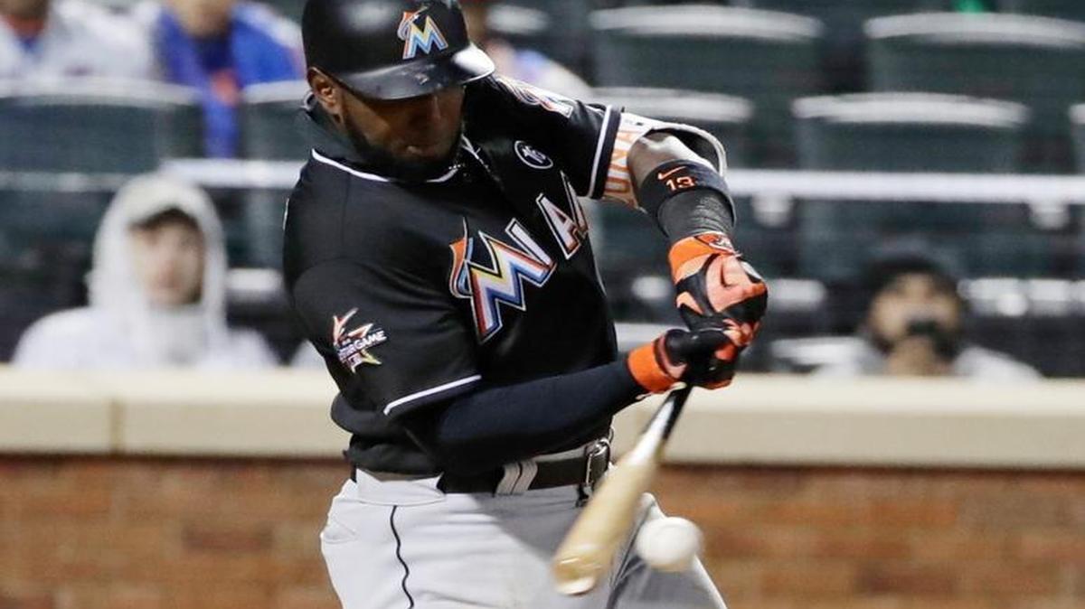 Miami Marlins' Marcell Ozuna hits an RBI single during the fifth inning of the team's baseball game against the New York Mets on Friday, April 7, 2017, in New York.