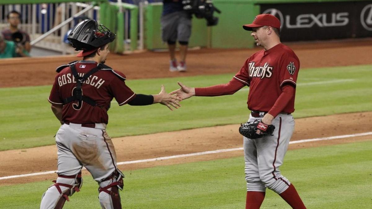 Arizona Diamondbacks pitcher Brad Ziegler — acquired by the Miami Marlins on Friday — shakes hands with catcher Tuffy Gosewisch after winning in the ninth inning during the team’s game against the Marlins at Marlins Park in Miami on May 20, 2015.