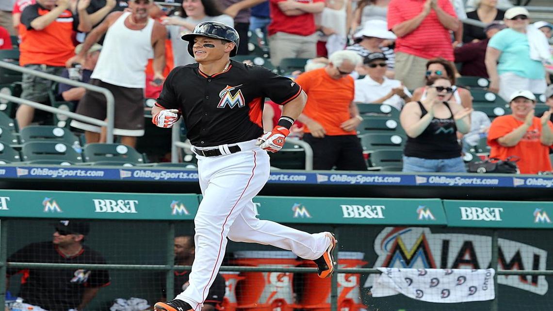 
Miami Marlins’ Derek Dietrich runs to home plate after hitting the winning home run in the ninth inning of a spring training game against the Washington Nationals at Roger Dean Stadium in Jupiter March 10, 2015.
