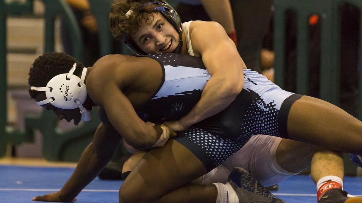 In this Feb. 24, 2018, file photo, Brevin Balmeceda, from South Dade, right, wrestles against Cardeionte Wilson, from Palmetto, during a 152 weight class Region 4-3A wrestling finals at Ronald W. Reagan Doral Senior High School.