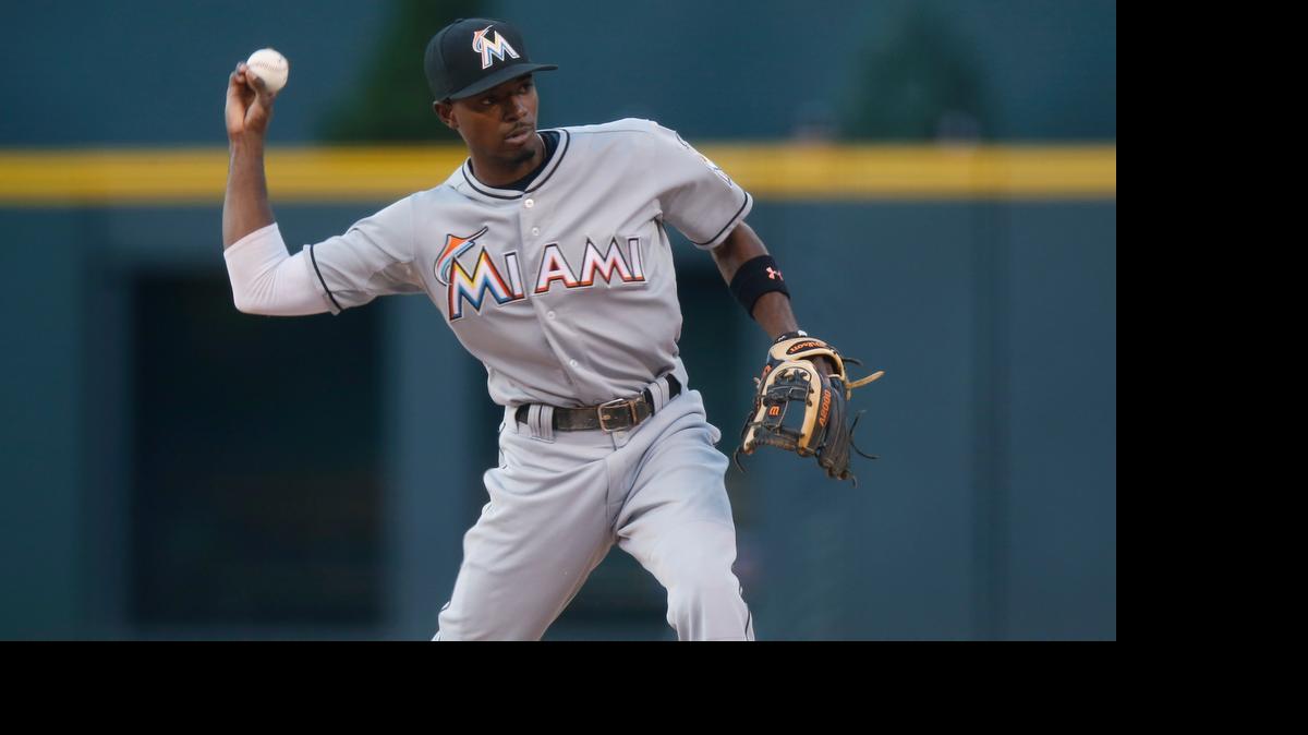 
Miami Marlins second baseman Dee Gordon throws to first base to put out Colorado Rockies' Charlie Blackmon in the first inning Friday, June 5, 2015, in Denver.
