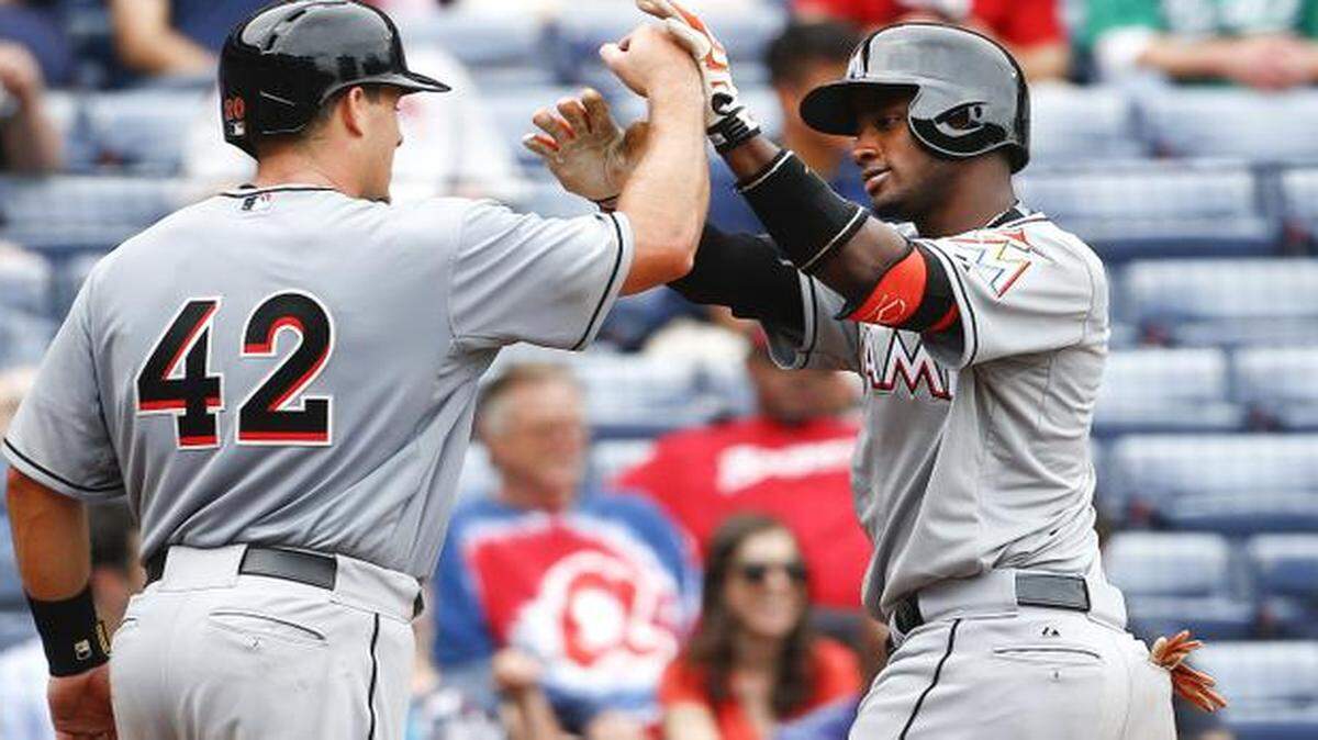 
Miami Marlins shortstop Adeiny Hechavarria, right, celebrates with catcher Jacob Realmuto after hitting a two-run home run in the fifth inning against the Atlanta Braves on Wednesday, April 15, 2015, in Atlanta. 
