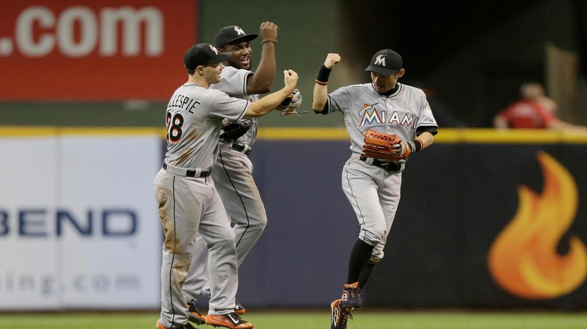 
Cole Gillespie #28 of the Miami Marlins celebrates with Ichiro Suzuki #51 and Marcell Ozuna #13 after the 9-6 win over the Milwaukee Brewers at Miller Park on August 18, 2015 in Milwaukee, Wisconsin.
