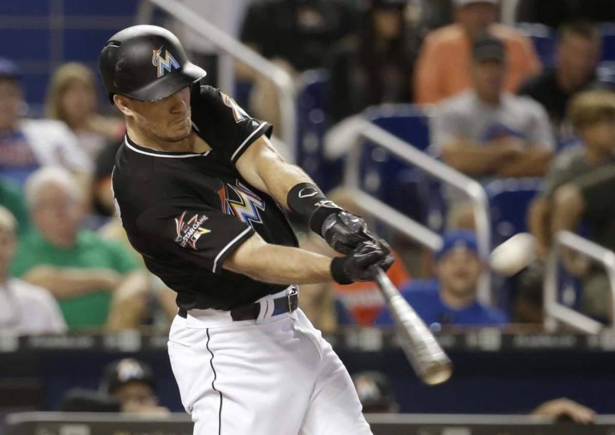 Miami Marlins' J.T. Realmuto hits a three-run home run during the first inning of a baseball game against the Chicago Cubs, Saturday, June 24, 2017, in Miami.