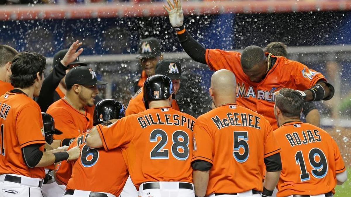
Adeiny Hechavarria, top right, is doused with water by his teammates after he hit a game-winning three-run home run against the San Diego Padres on Sunday, Aug. 2, 2015.
