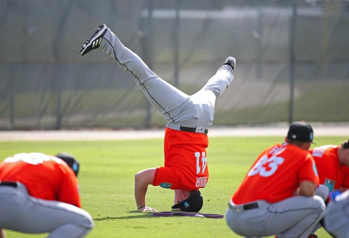 Miami Marlins first baseman Justin Bour do a headstand during the spring training baseball workouts at Roger Dean Stadium on Tues., February 20, 2018 in Jupiter, FL.