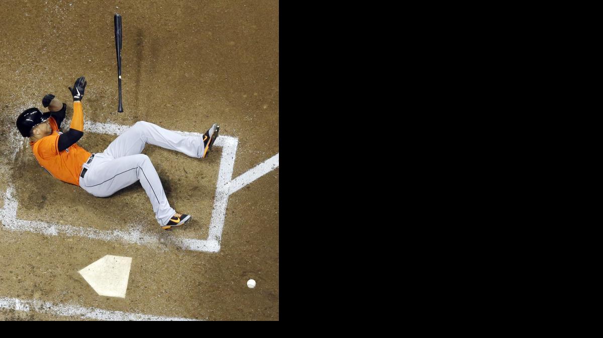 
The Marlins’ Giancarlo Stanton falls down after being hit in the face with a pitch during the fifth inning of Thursday night’s game against the Milwaukee Brewers. Stanton was taken off the field on a stretcher. 
