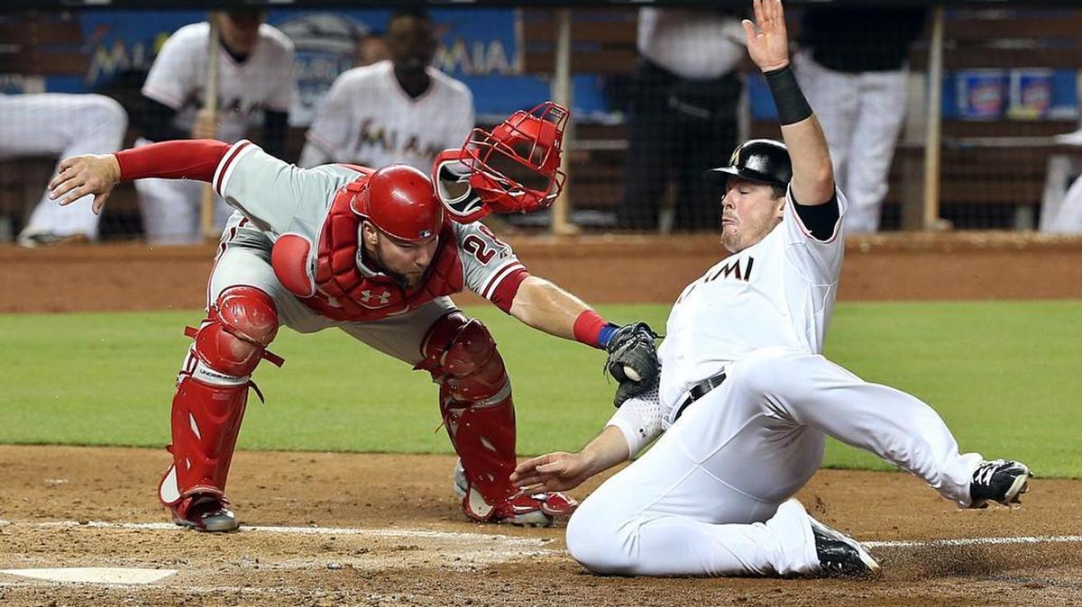 
Justin Bour of the Miami Marlins is tagged out at home by Philadelphia Phillies catcher Cameron Rupp in the fourth inning at Marlins Park on Friday, Aug. 21, 2015.
