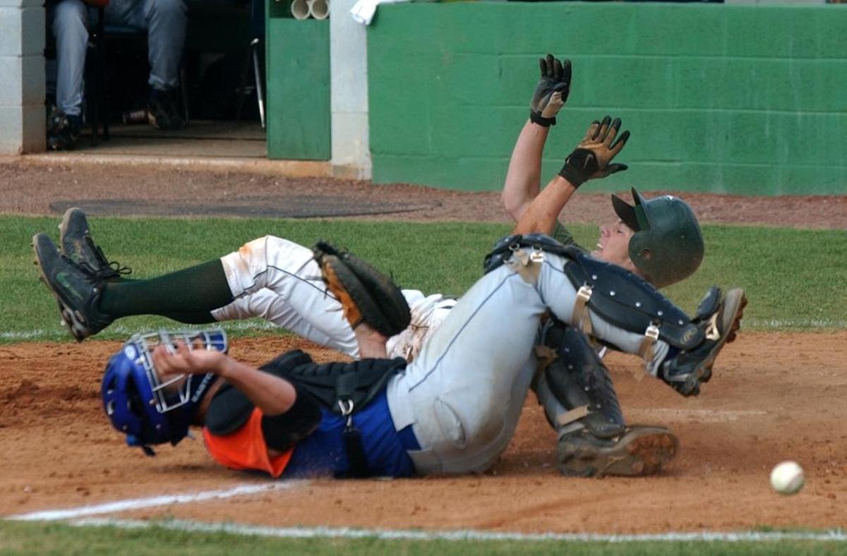 Flanagan’s J.D. Martinez gets past Palm Beach Gardens catcher Andrew Karmeris in a 2006 regional playoff game.