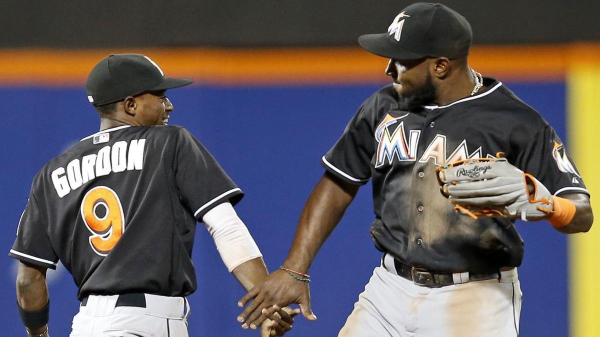 
Miami Marlins second baseman Dee Gordon (9) and center fielder Marcell Ozuna celebrate after the Marlins' 9-3 win over the New York Mets in New York, Tuesday, Sept. 15, 2015. 
