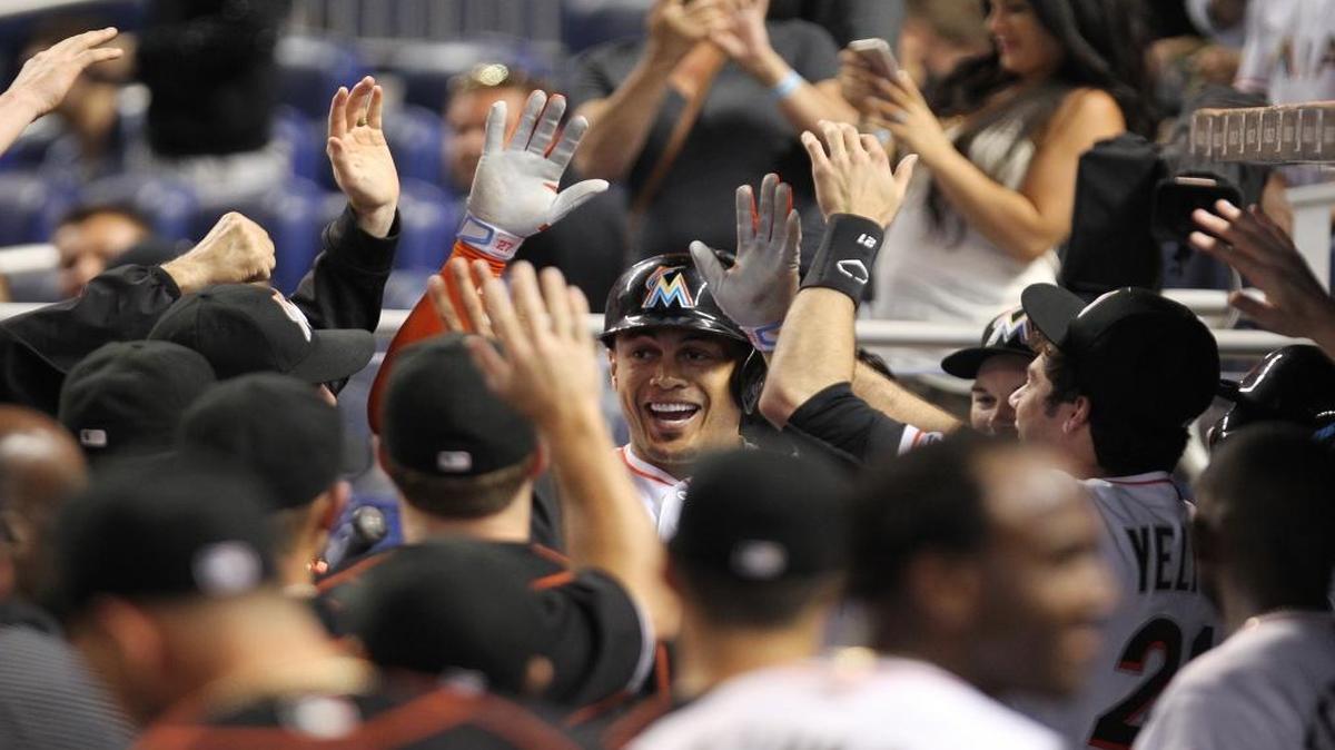 Miami Marlins right fielder Giancarlo Stanton (27) celebrates with his teammates in the dugout after hitting the second home run of the game in the first inning during the last game of the series against the Colorado Rockies at Marlins Park on Mon., June 20, 2016.