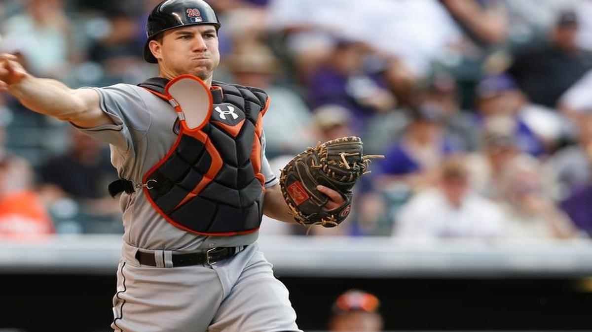 
Miami Marlins catcher J.T. Realmuto throws to first base to put out Colorado Rockies first baseman Wilin Rosario in the ninth inning of a baseball game Sunday, June 7, 2015, in Denver. The Marlins won 3-2 in 10 innings.
