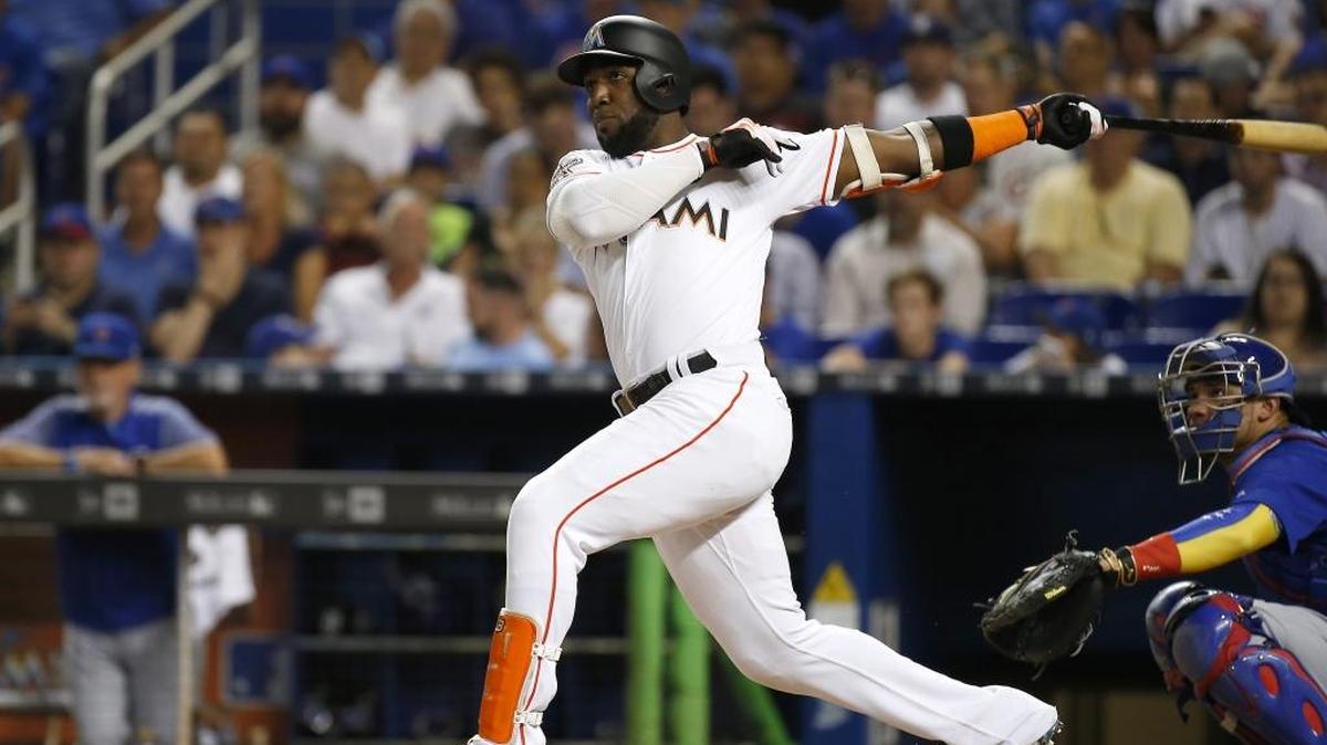 Miami outfielder Marcell Ozuna hits a solo home run during the second inning against the Cubs at Marlins Park on Thursday.