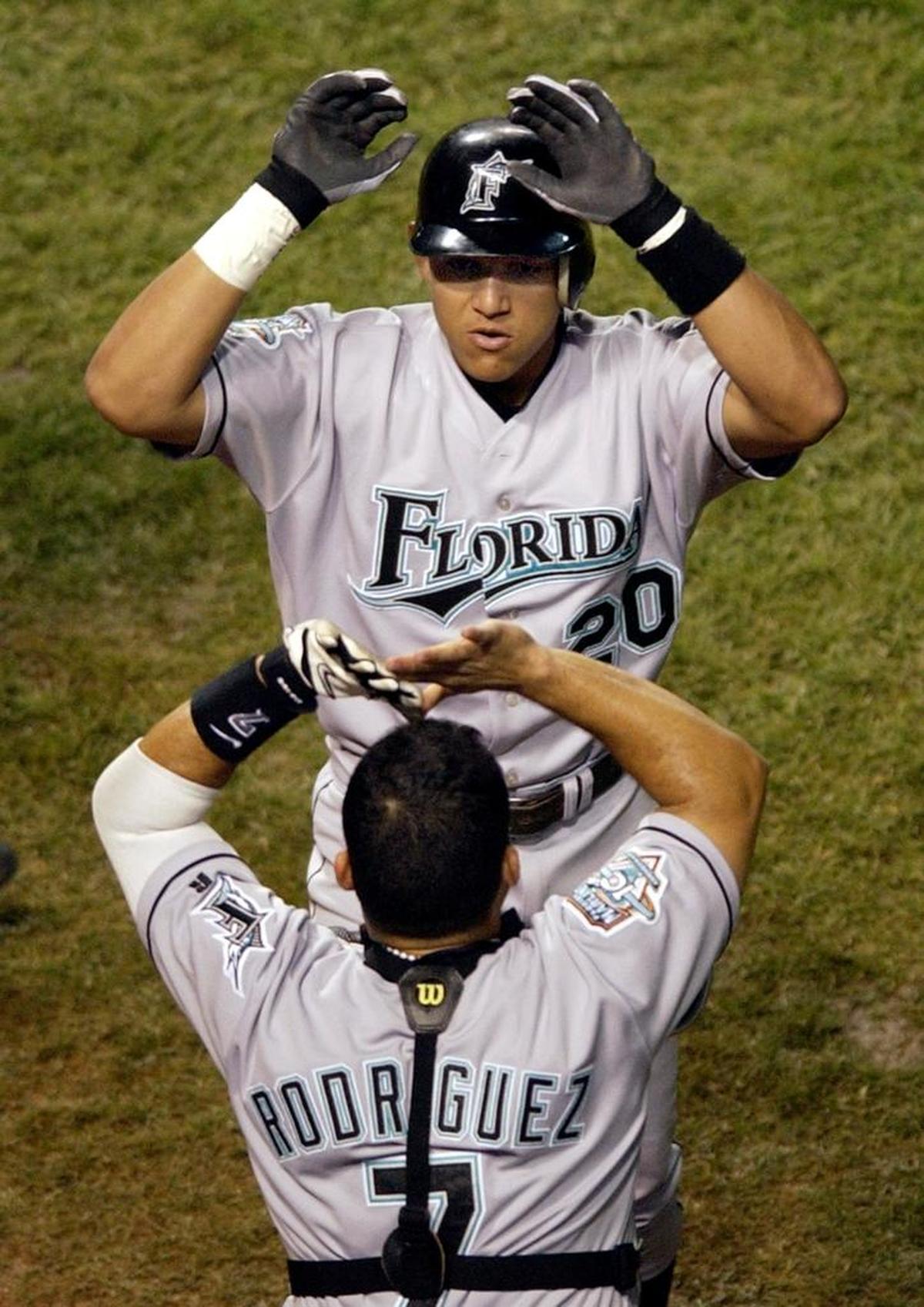 Florida’a Miguel Cabrera is greeted by teammate Ivan Rodriguez after his solo homer in the third inning against the Chicago Cubs in Game 1 of the National League championship series on Oct. 7, 2003 at Wrigley Field.