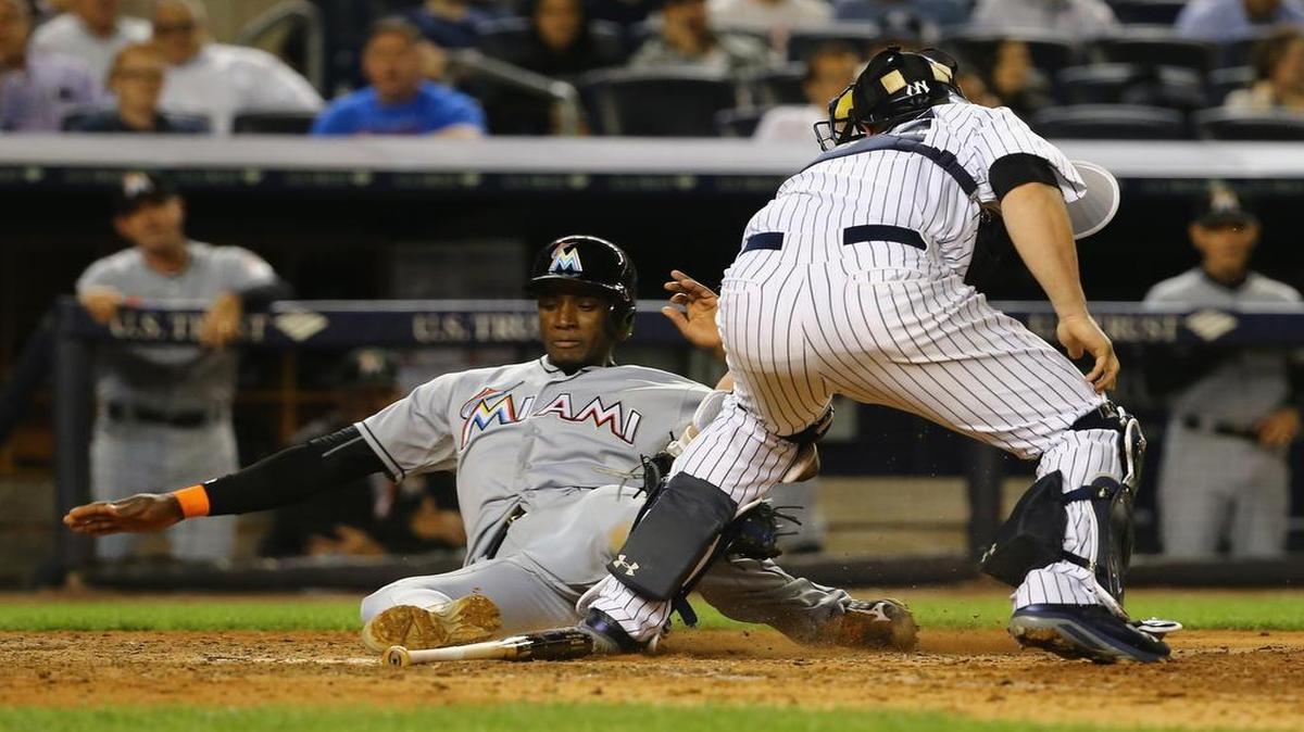 
Adeiny Hechavarria #3 of the Miami Marlins is tagged out by Brian McCann #34 of the New York Yankees in the eigth inning during their game at Yankee Stadium on June 17, 2015 in New York City. 
