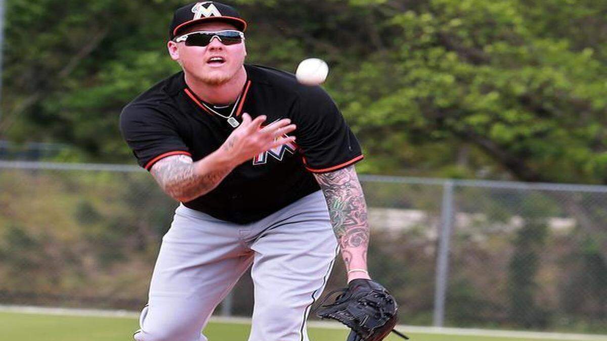 
Miami Marlins pitcher Mat Latos throws to first base during the spring training full-squad workouts at Roger Dean Stadium on Jupiter Tuesday, Feb. 24, 2015.
