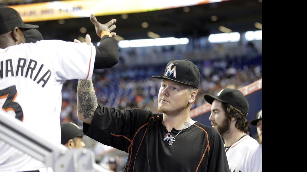 
Miami Marlins pitcher Mat Latos, right, greets shortstop Adeiny Hechavarria (3) before a baseball game against the Washington Nationals, Thursday, July 30, 2015, in Miami. 

