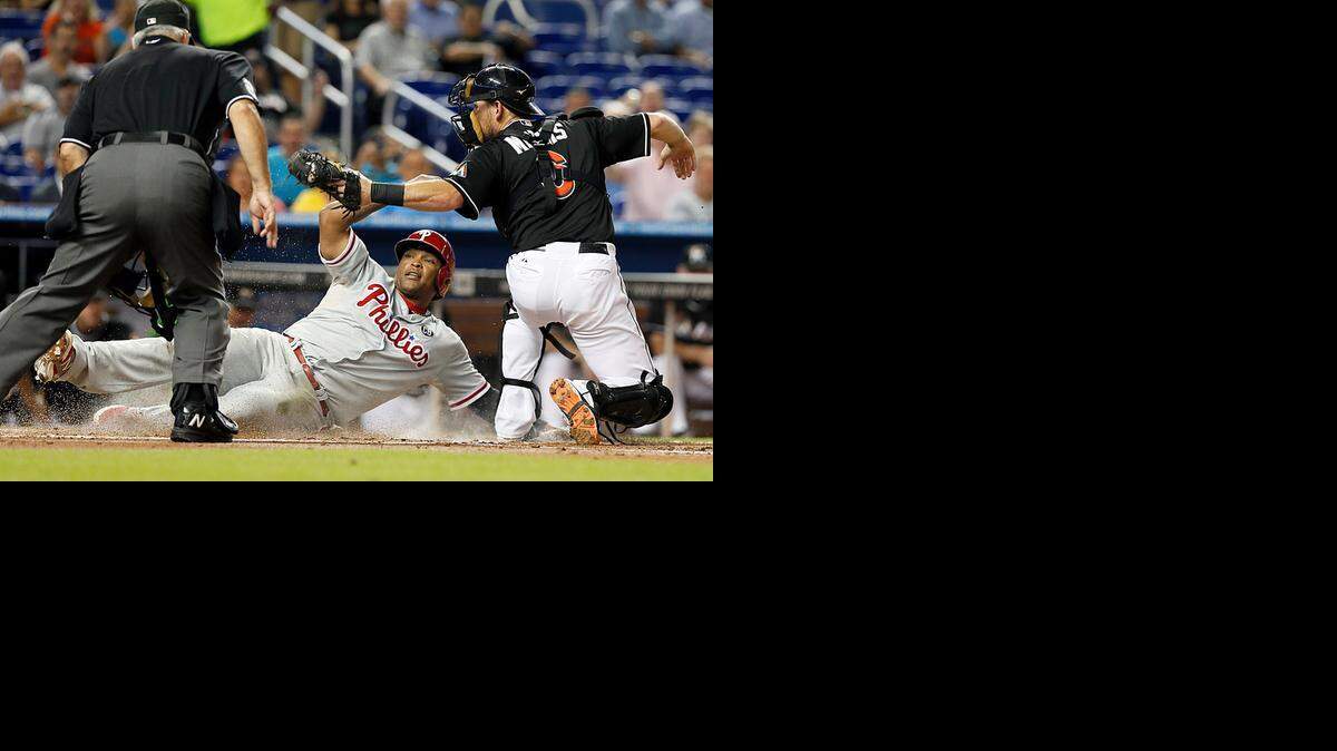 
Jeff Mathis tags out Marlon Byrd at home plate in the second inning of the Miami Marlins' game against the Philadelphia Phillies at Marlins Park in Miami on Wednesday, Sept. 24, 2014.
