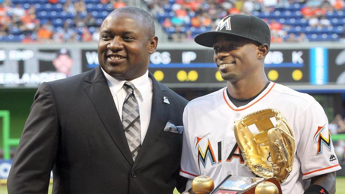 Michael Hill, Miami Marlins' President, Baseball Operations, poses with second baseman Dee Gordon, as he received his 2015 Rawlings Golden Glove Award, before the Marlins' home opener against the Detroit Tigers on Tues., April 5, 2016, at Marlins Park.