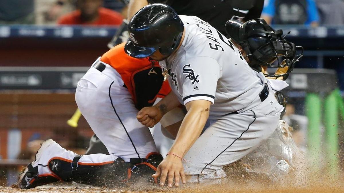 Chicago White Sox pinch-runner Carlos Sanchez (5) collides with Miami Marlins catcher Jeff Mathis as he is tagged out to end the baseball game, Sunday, Aug. 14, 2016, in Miami. Sanchez tried to score from second base on a two-out single. The Marlins won 5-4.