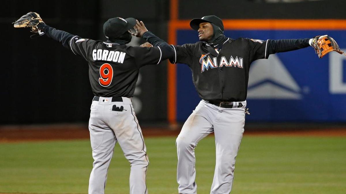 Marlins second baseman Dee Gordon, left, and shortstop Adeiny Hechavarria celebrate after several factors came together Tuesday, allowing them to pull out a 2-1 victory.