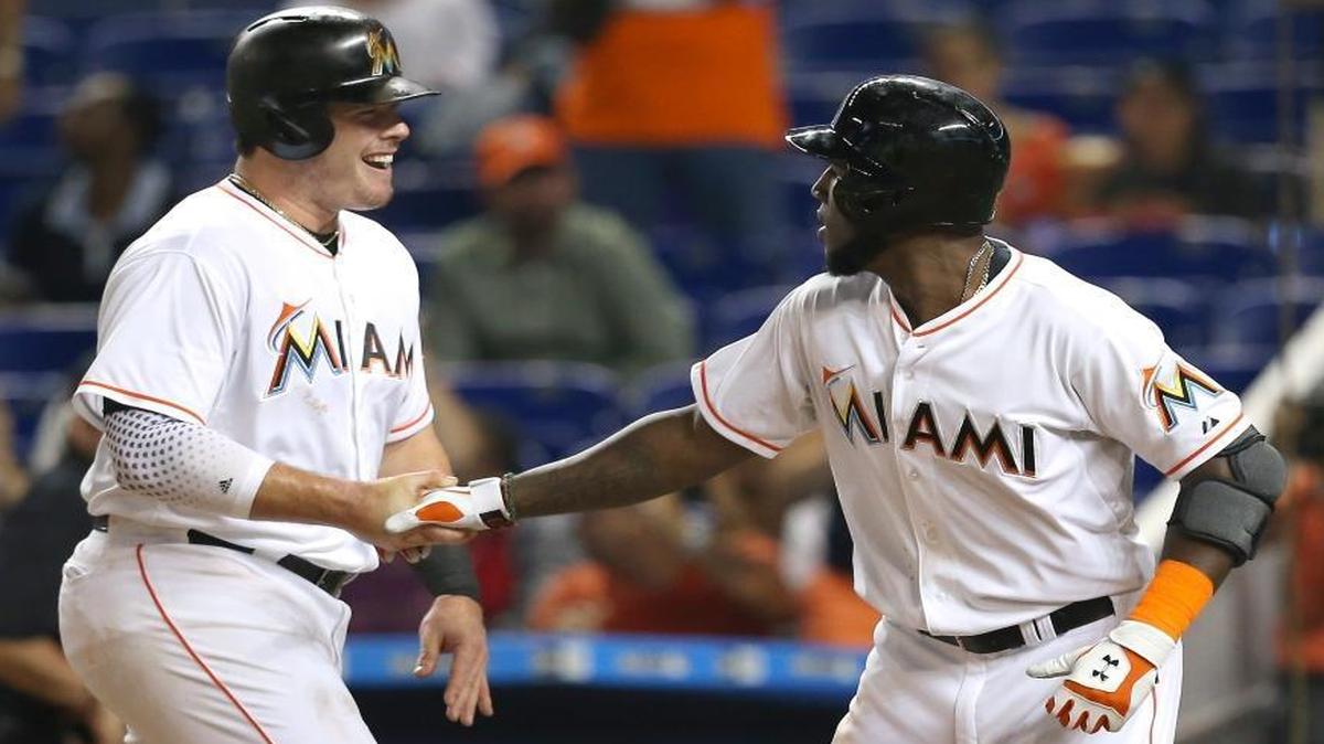 Marcell Ozuna is congratulated by Justin Bour, left, after hitting a two-run home run against the Phillies on August 20, 2015, at Marlins Park.