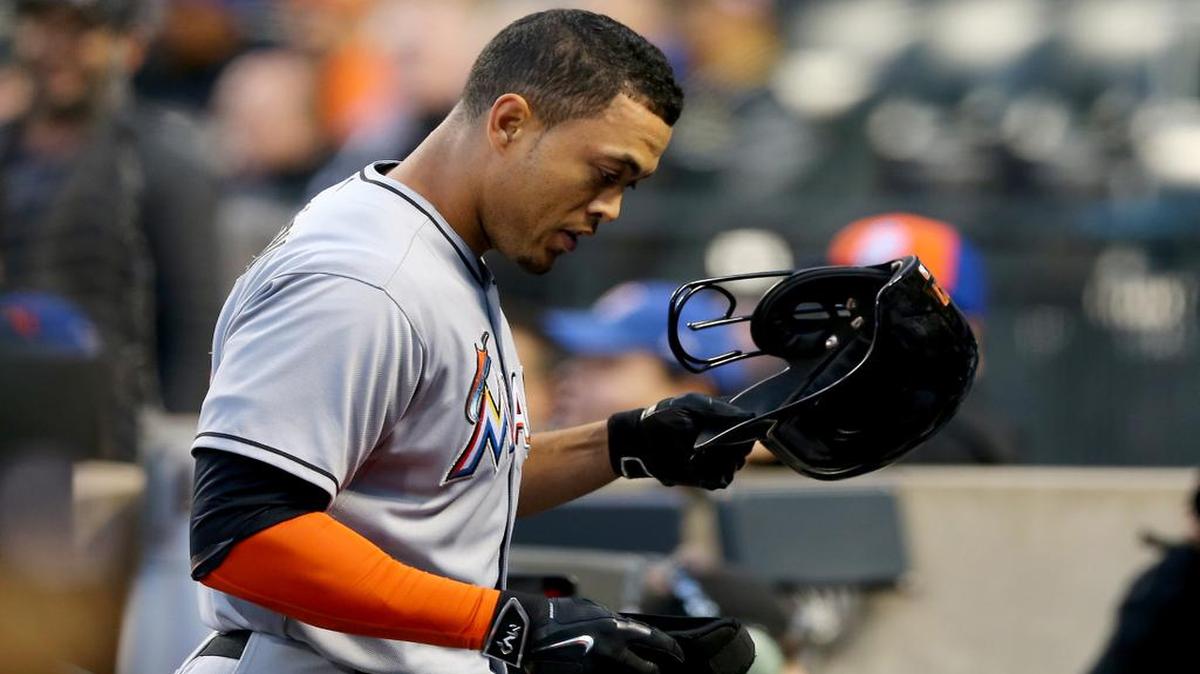
Giancarlo Stanton #27 of the Miami Marlins heads into the dugout after hitting a two run homer in the first inning against the New York Mets on April 16, 2015 at Citi Field in the Flushing neighborhood of the Queens borough of New York City. 
