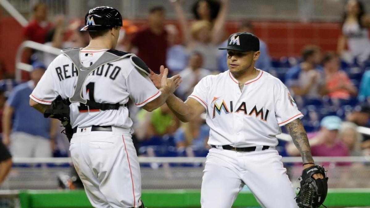 Miami Marlins catcher J.T. Realmuto, left, and relief pitcher A.J. Ramos congratulate each other after the Marlins defeated the Pittsburgh Pirates 3-2 in a baseball game, Wed., June 1, 2016, in Miami.