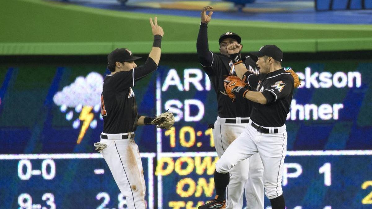 
Miami Marlins left fielder Christian Yelich (21), center fielder Marcell Ozuna (13) and right fielder Ichiro Suzuki (51)celebrate after a baseball game against the Los Angeles Dodgers in Miami, Saturday, June 27, 2015. The Marlins won 3-2.
