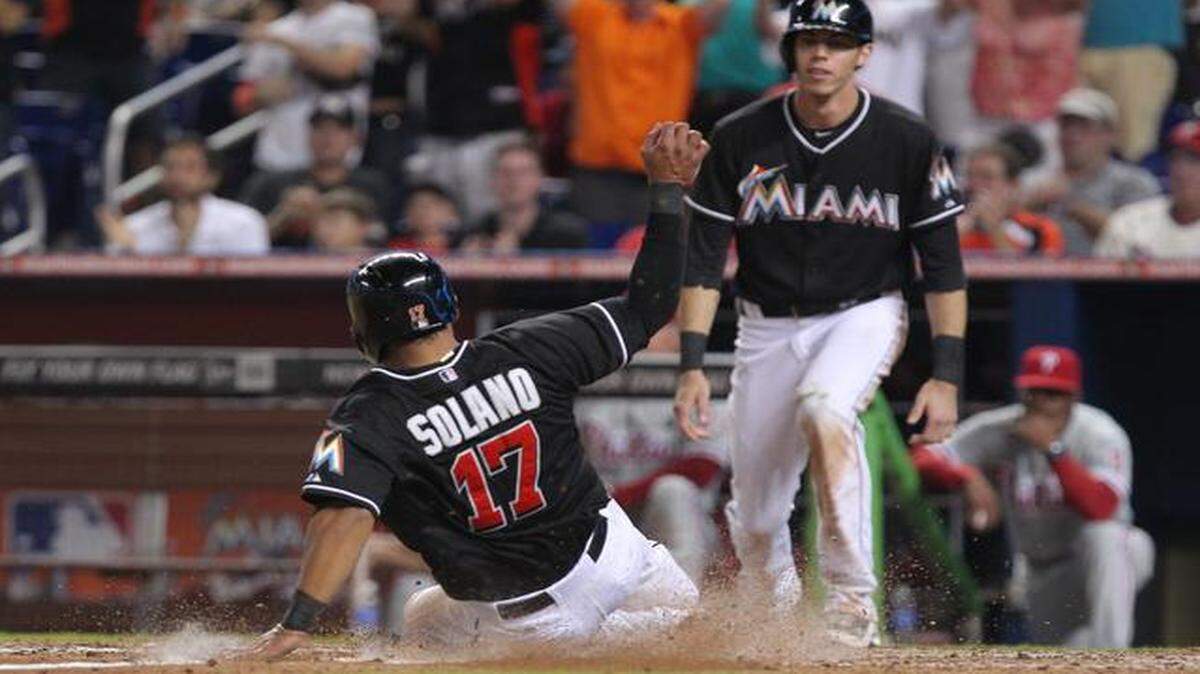 Safe at home:  Donovan Solano scores during the Marlins’ four-run seventh inning against the Phillies in the last home game of the season Thursday,