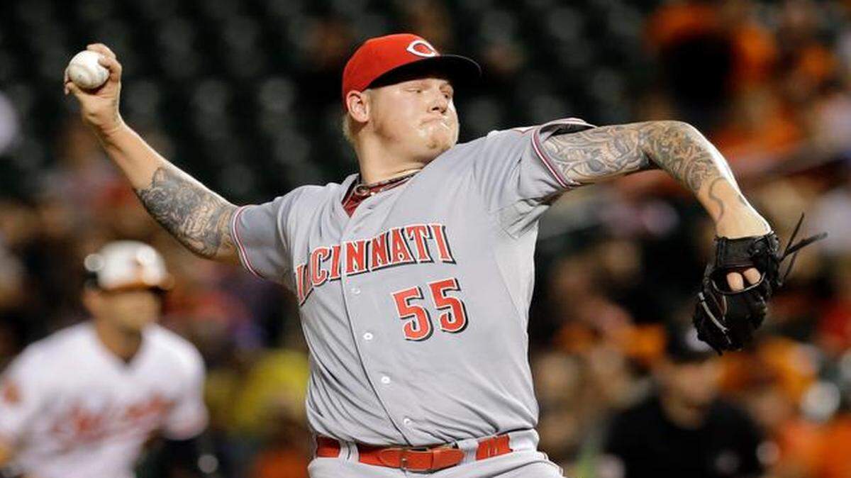 
FILE - In this Sept. 2, 2014, file photo, Cincinnati Reds starting pitcher Mat Latos throws to the Baltimore Orioles in the first inning of an interleague baseball game in Baltimore. The Miami Marlins have acquired right-hander Mat Latos from the Cincinnati Reds for pitching prospect Anthony DeSclafani and catcher Chad Wallach, their second big deal in less than 12 hours, Thursday, Dec. 11, 2014.
