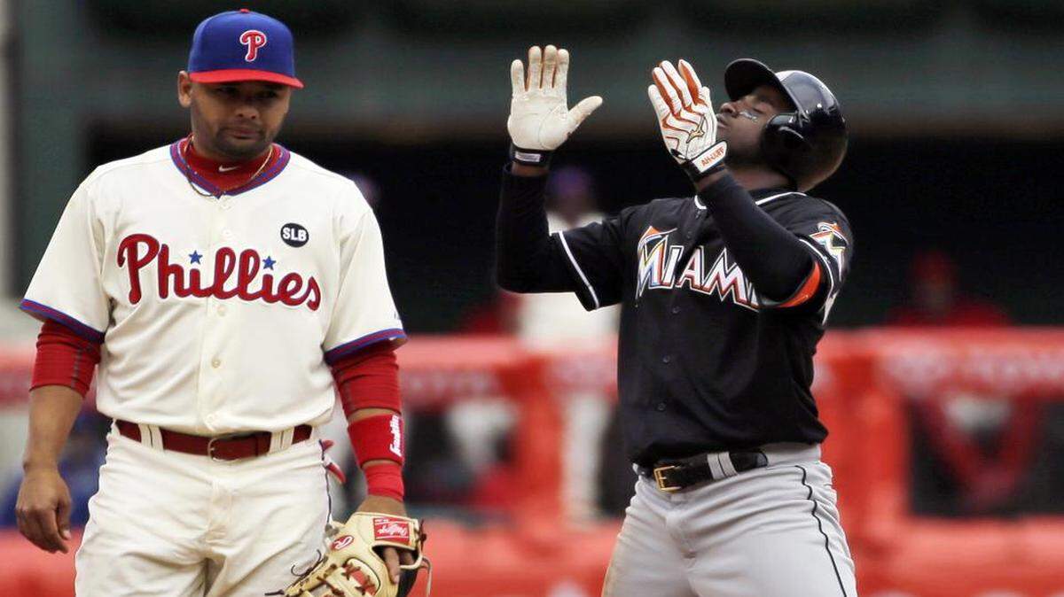 
The Marlins’ Adeiny Hechavarria, right, reacts after hitting a two-run double during the fourth inning Thursday, April 23, 2015, in Philadelphia. At left is Phillies shortstop Andres Blanco. 

