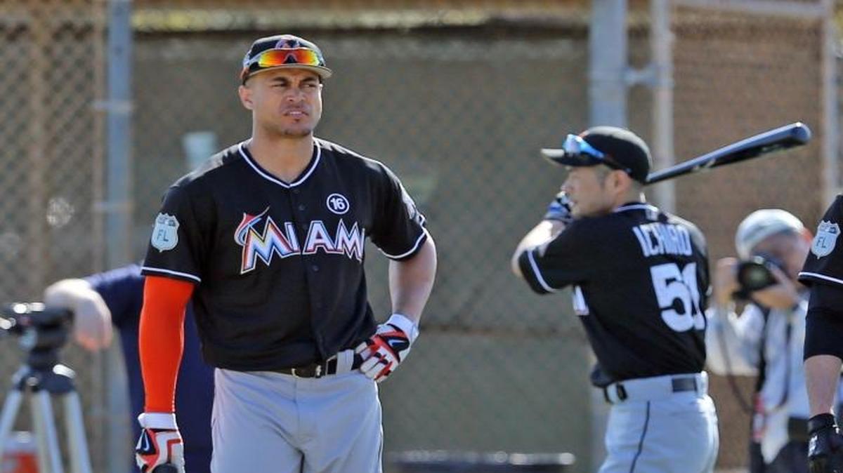 Giancarlo Stanton, Ichrio Suzuki, and Christian Yelich wait to bat on the first day of full squad practice at the Miami Marlins training facility in Jupiter on Feb. 17, 2017.