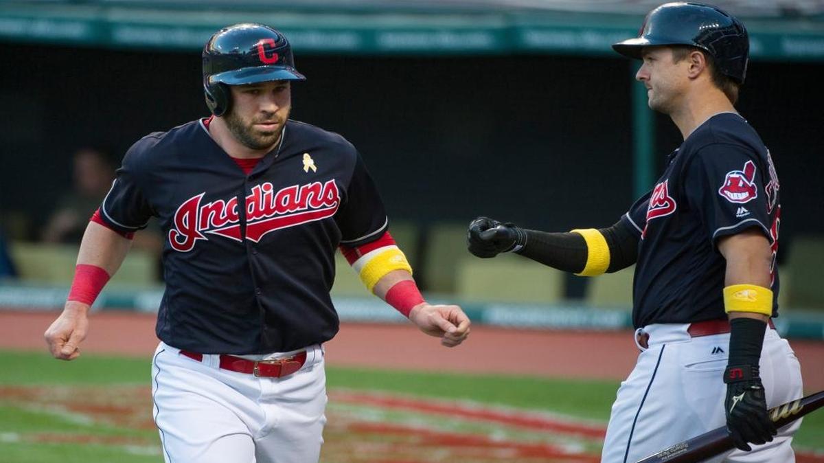 Cleveland Indians' Jason Kipnis is greeted by teammate Lonnie Chisenhall after scoring against the Miami Marlins during the first inning of a baseball game in Cleveland, Fri., Sept. 2, 2016.