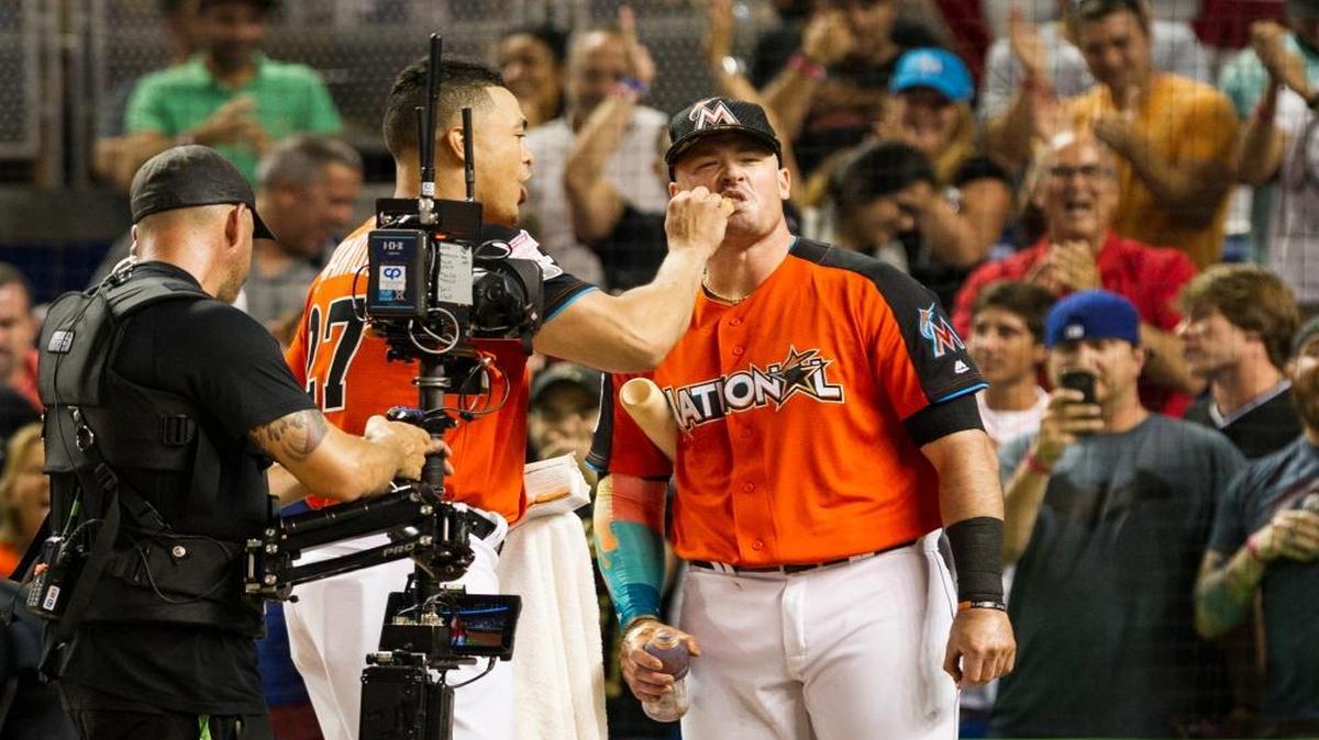 Marlins outfielder Giancarlo Stanton feeds a doughnut to Justin Bour during a break in Monday’s MLB Home Run Derby. Stanton and Bour were eliminated in the first round.
