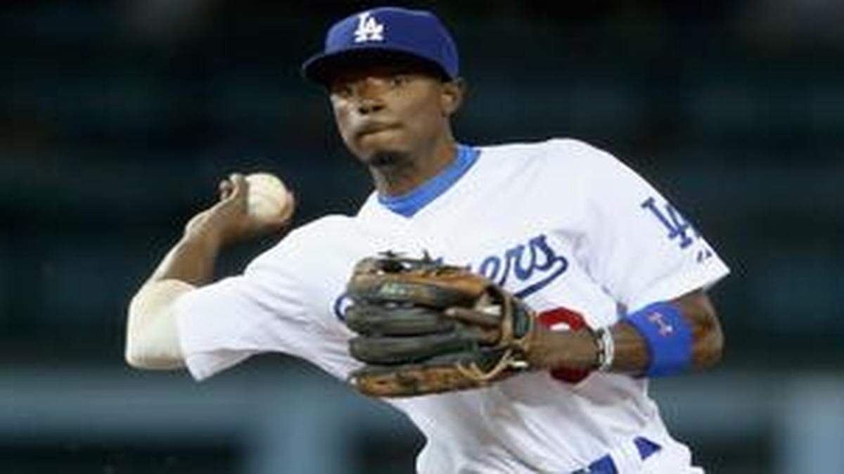 
Second baseman Dee Gordon of the Dodgers forces out Joe Panik of the San Francisco Giants at second before throwing to first to complete the double play at Dodger Stadium on Sept. 24, 2014. 
