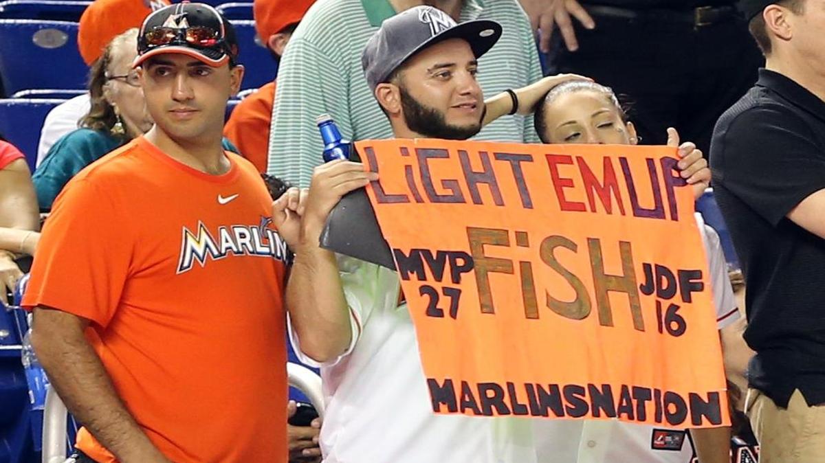 
A Marlins fan holds a sign on Opening Day against the Atlanta Braves. The Marlins are 8-14 this season at home.
