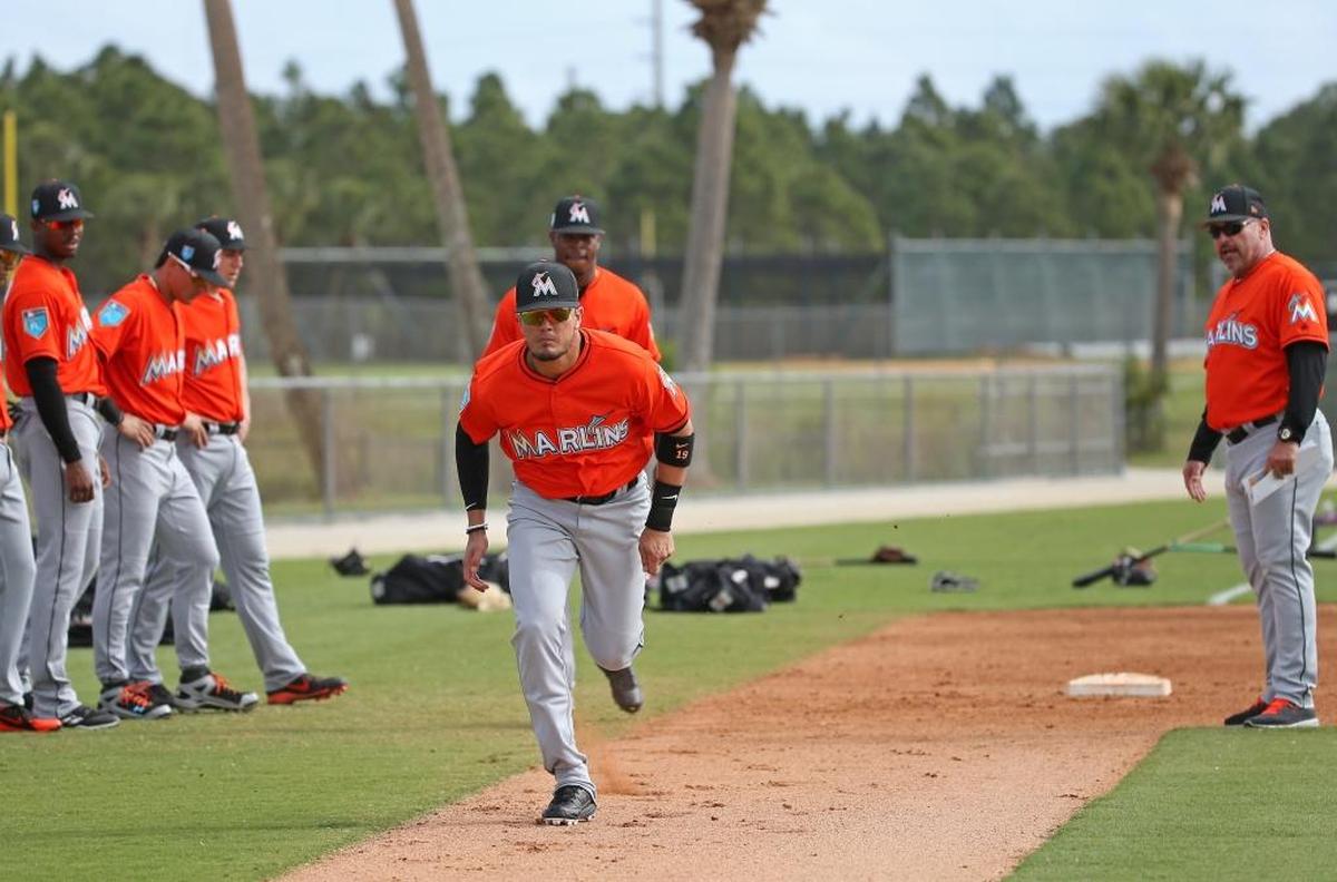 Miami Marlins infielder Miguel Rojas runs into home plate during the spring training baseball workouts at Roger Dean Stadium on Tues., Feb. 20, 2018 in Jupiter, FL.